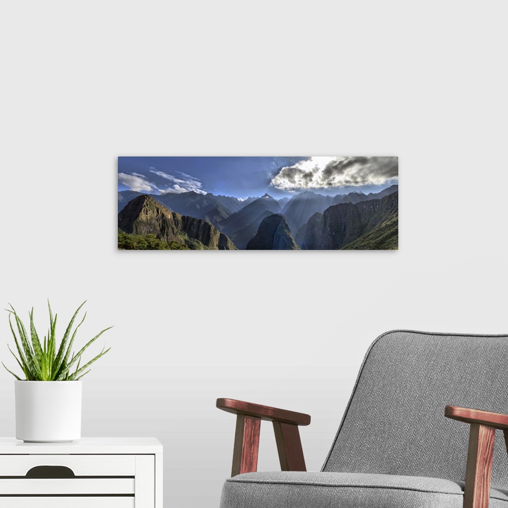 A modern room featuring View of Andes Mountain Range from Machu Picchu. Beautiful scenery with sun rays shining through t...