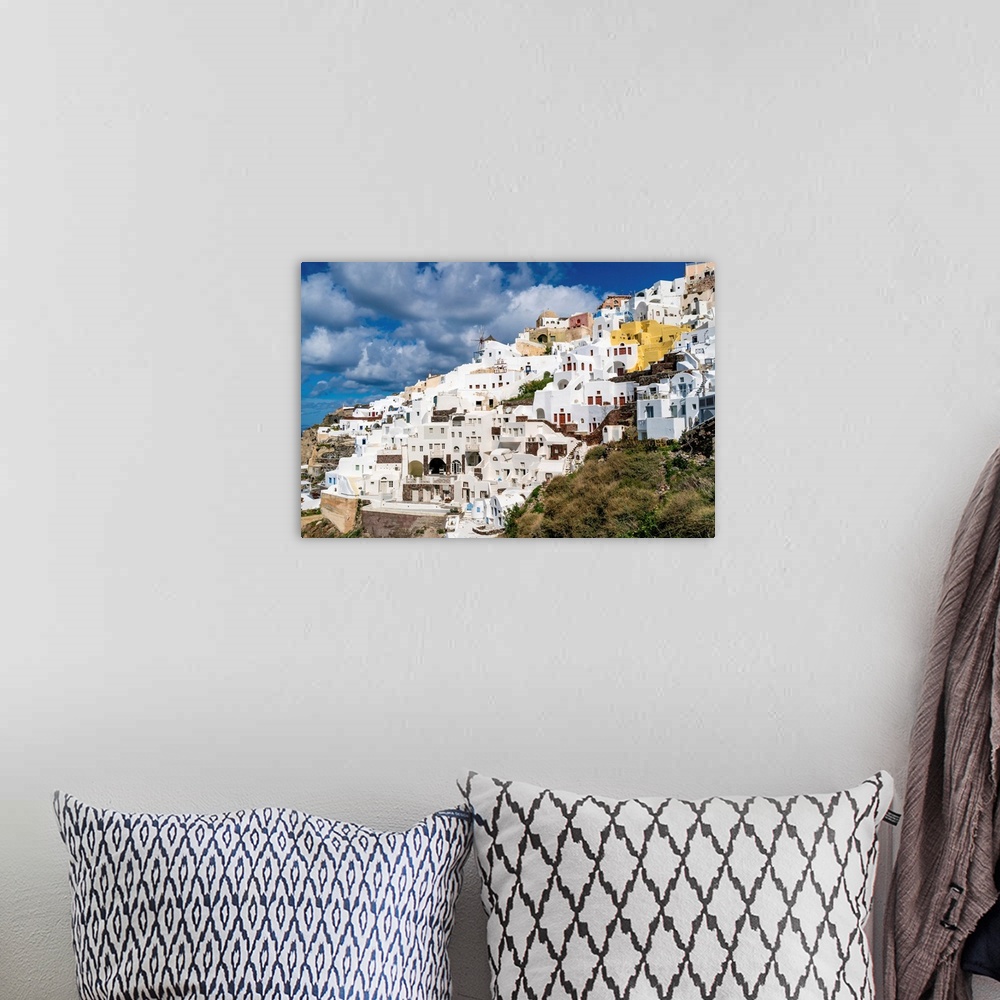 A bohemian room featuring White houses near windmill in Santorini island.