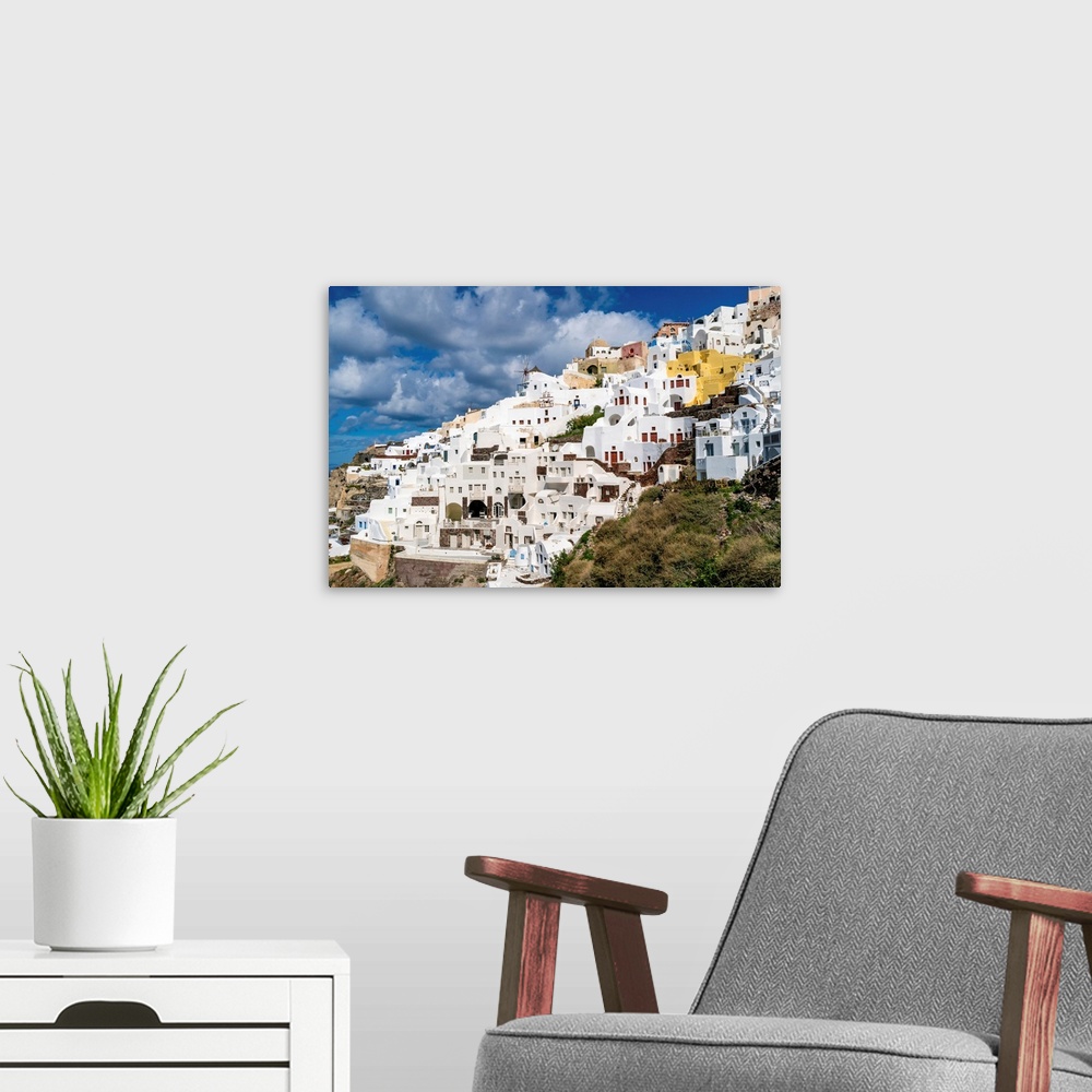 A modern room featuring White houses near windmill in Santorini island.