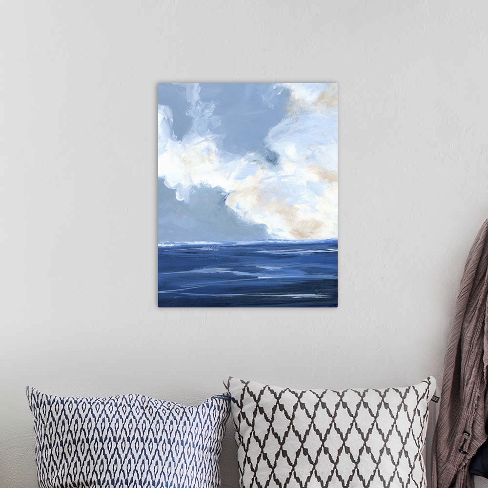 A bohemian room featuring Contemporary painting of a calm ocean with large white clouds on the horizon.