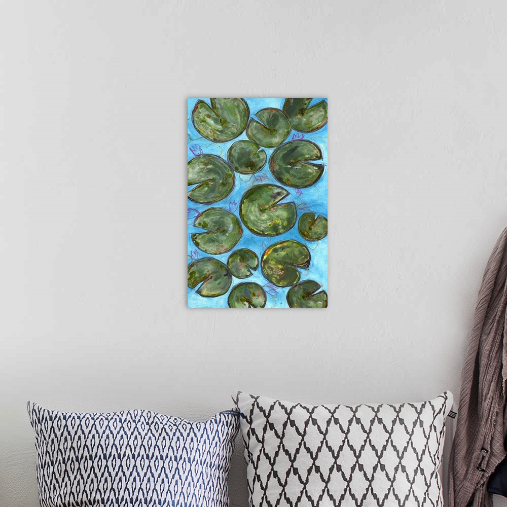 A bohemian room featuring Large painting of lily pads on a blue background with thin pink, purple, orange, and yellow layer...