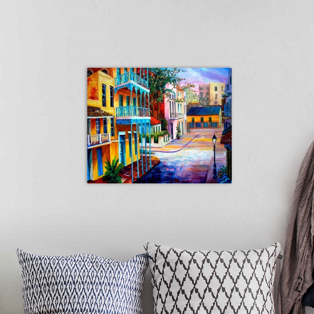 A bohemian room featuring Landscape painting on a large wall hanging of the sun rising over the streets of French Quarter i...