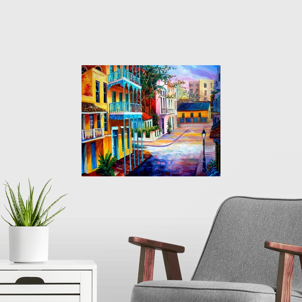 A modern room featuring Landscape painting on a large wall hanging of the sun rising over the streets of French Quarter i...