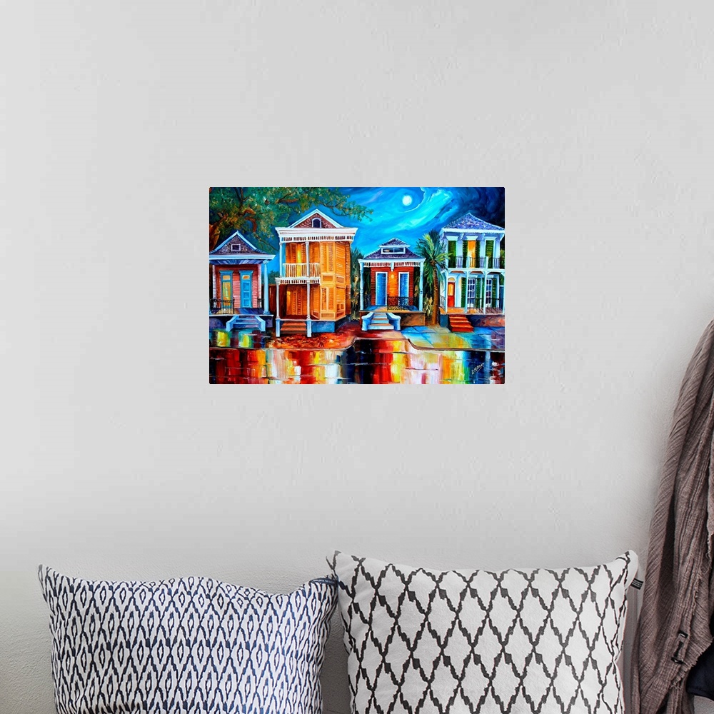 A bohemian room featuring This contemporary nighttime scene features a row of historic shotgun houses in New Orleans. The b...