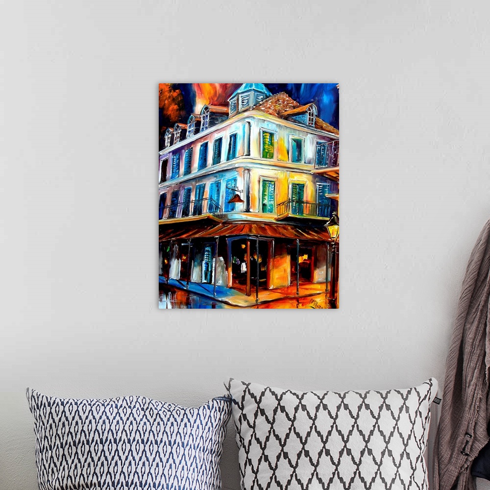 A bohemian room featuring Painting of building on street corner with two story balcony under a dark stormy sky.