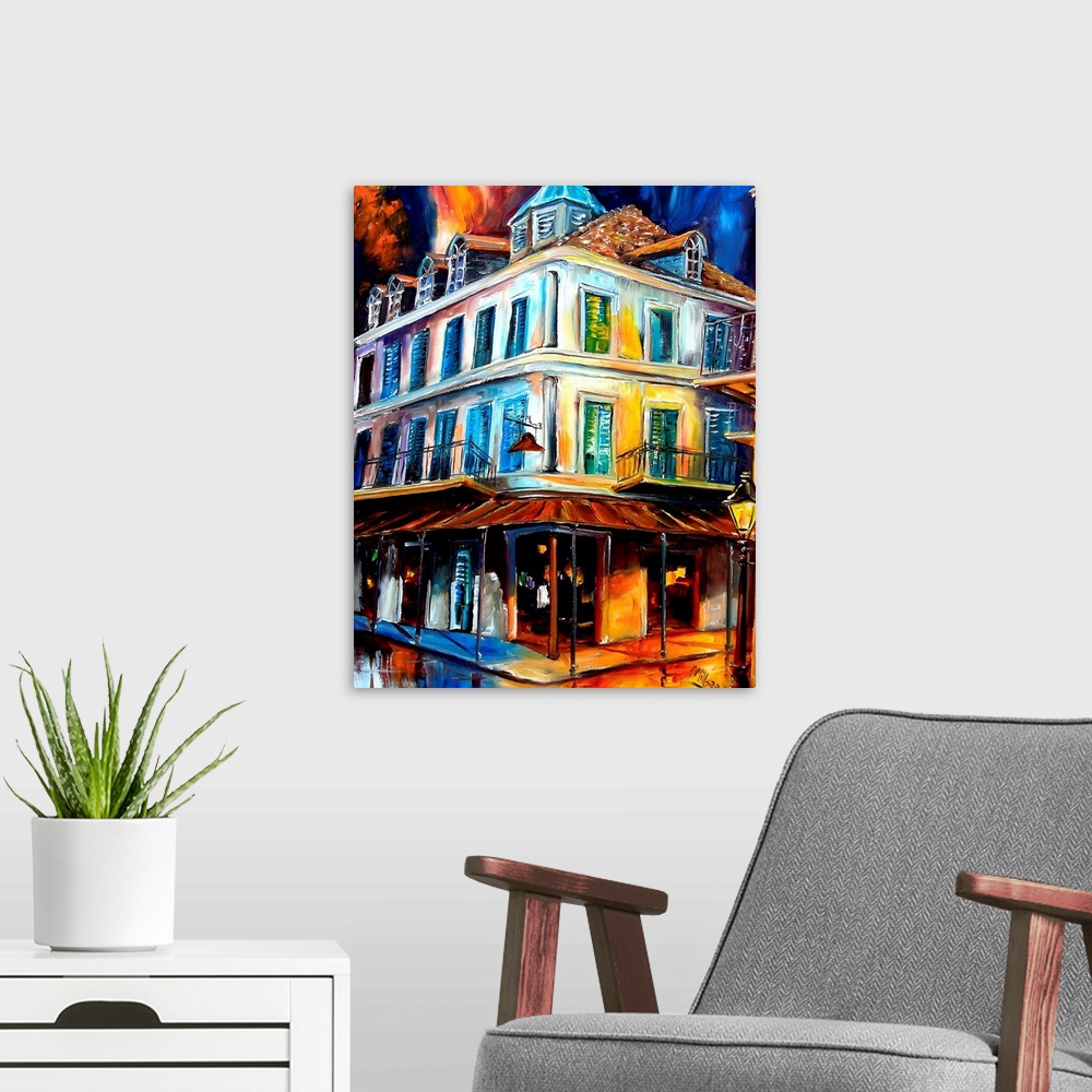 A modern room featuring Painting of building on street corner with two story balcony under a dark stormy sky.