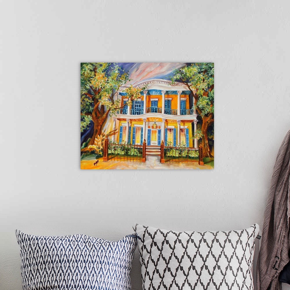A bohemian room featuring Painting of a yellow house located in the Garden District in New Orleans, LA.