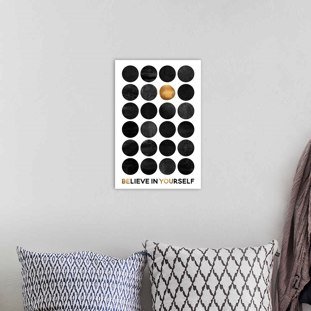 A bohemian room featuring A grid of dark grey circles with one gold circle on a white background, with the words Believe in...