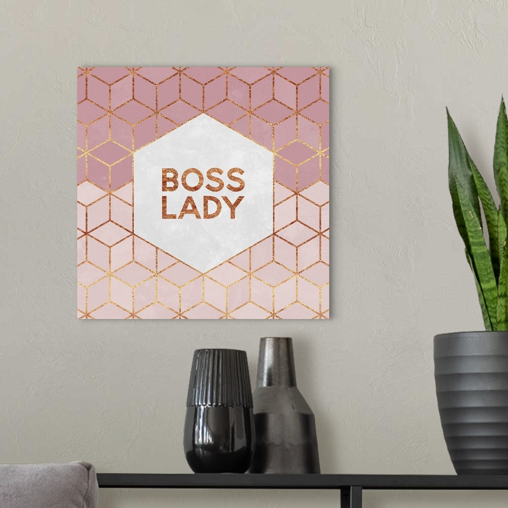 A modern room featuring The words 'Boss Lady' in gold letters, centered on a white hexagon surrounded by rose pink diamon...