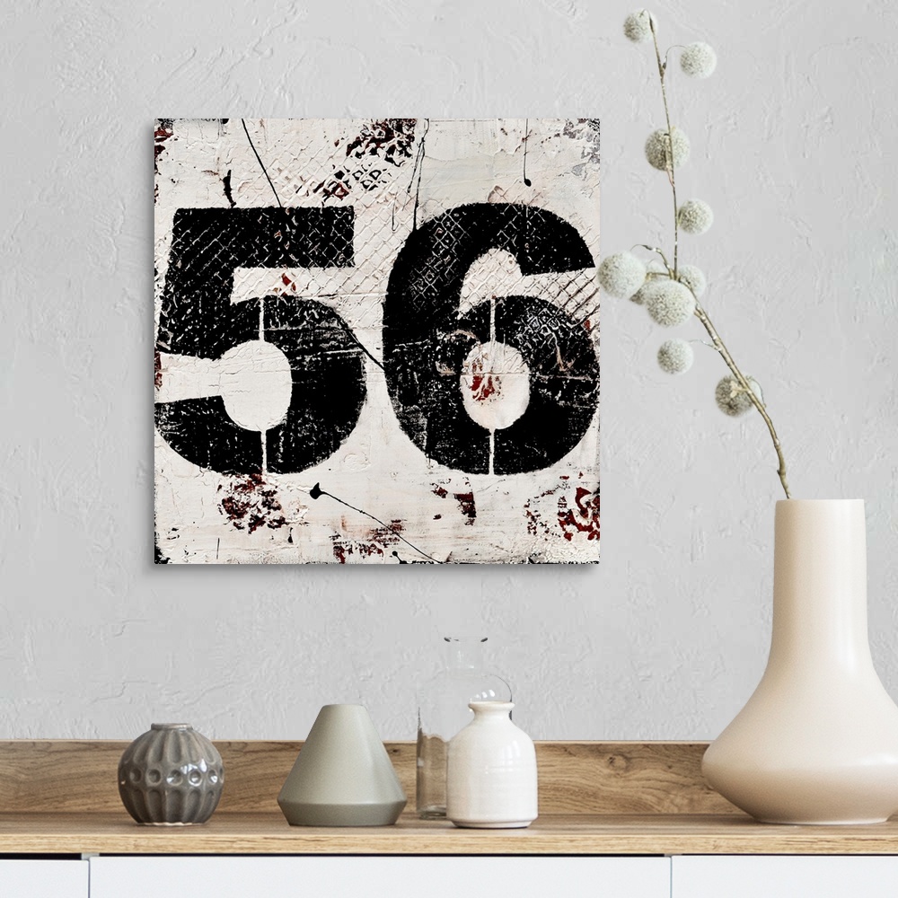 A farmhouse room featuring A contemporary abstract painting using a neutral toned background with a bold black number fifty-...