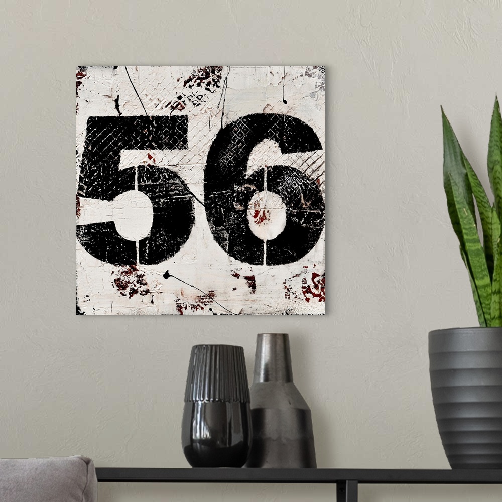 A modern room featuring A contemporary abstract painting using a neutral toned background with a bold black number fifty-...