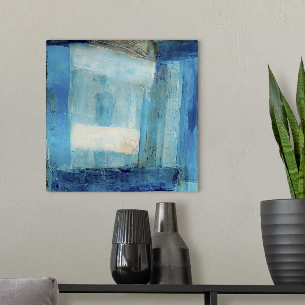 A modern room featuring Abstract contemporary art print in color blocks of varying shades of deep blue.