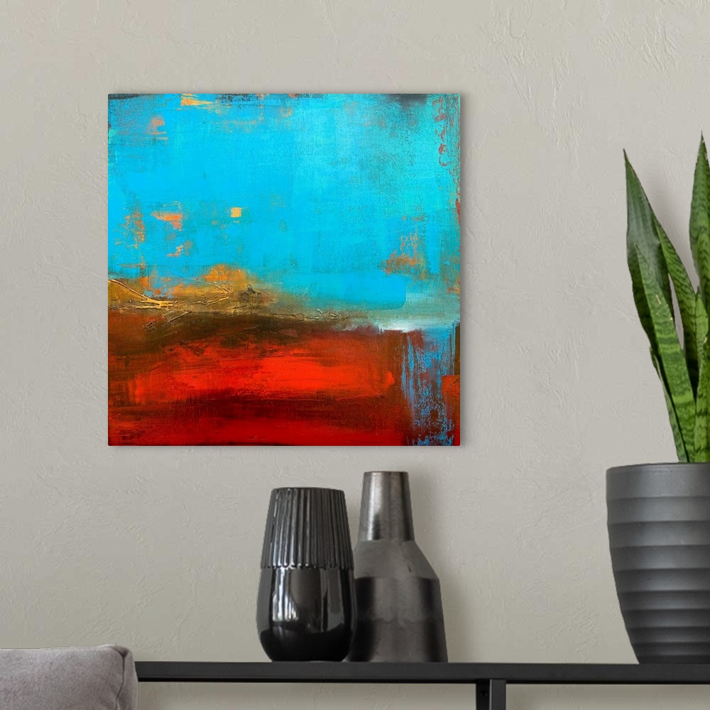 A modern room featuring Abstract canvas painting of cool tones meeting warms tones.