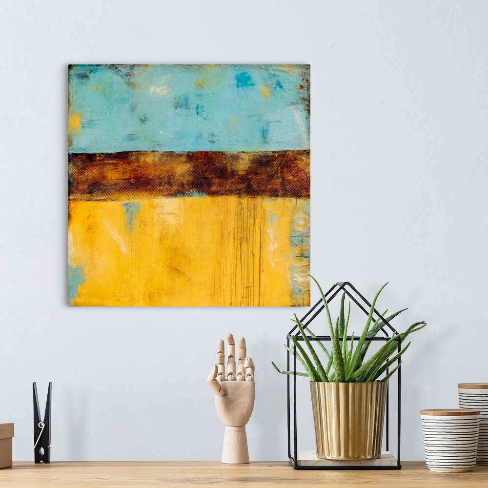 A bohemian room featuring Square abstract painting created with shades of blue and yellow with a thick, textured, brown, ho...