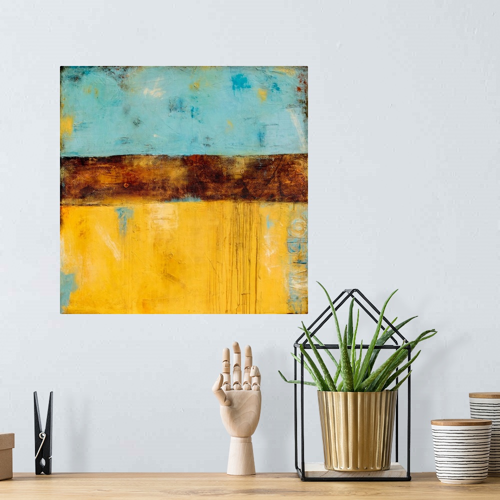 A bohemian room featuring Square abstract painting created with shades of blue and yellow with a thick, textured, brown, ho...