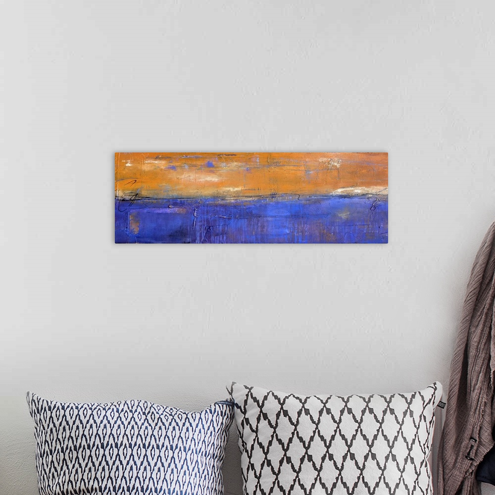 A bohemian room featuring Panoramic abstract painting in bold orange and blue hues with white coming through and thin, blac...