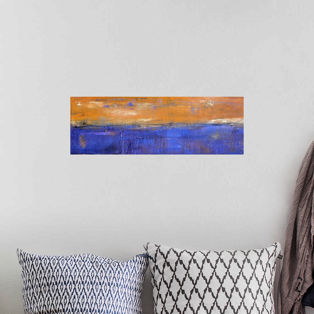 A bohemian room featuring Panoramic abstract painting in bold orange and blue hues with white coming through and thin, blac...