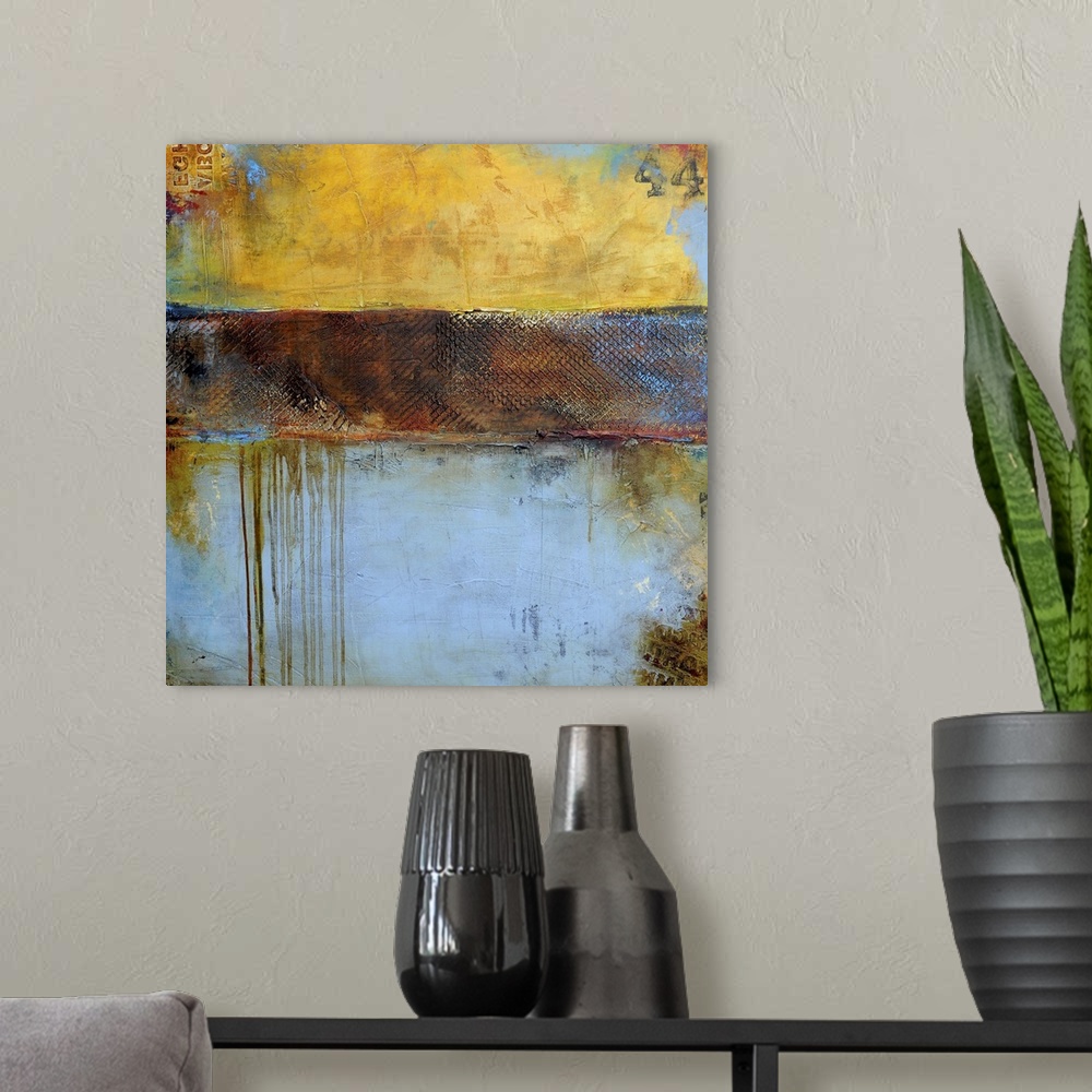 A modern room featuring Contemporary abstract painting of a color-field of weathered yellow brown and pale blue tones.