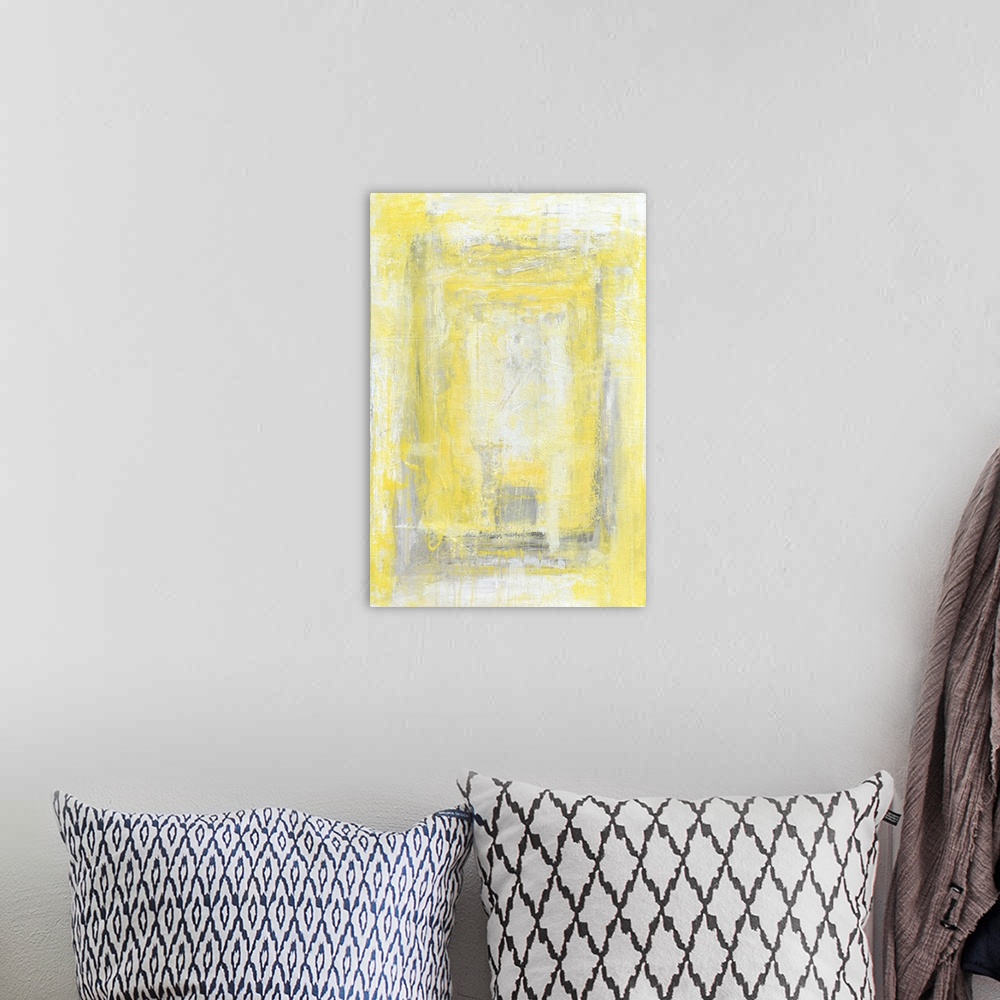 A bohemian room featuring A contemporary abstract painting using pale yellow and white in concentric boxes.