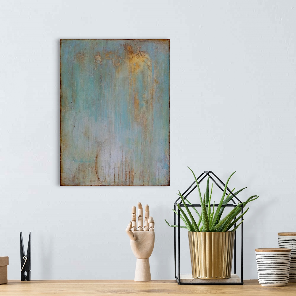 A bohemian room featuring Vertical abstract painting created with a muted blue turning into gray with streaking lines in go...