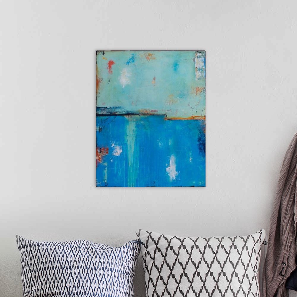 A bohemian room featuring Abstract painting with a cool blue toned background and warm pops of red and orange on top giving...