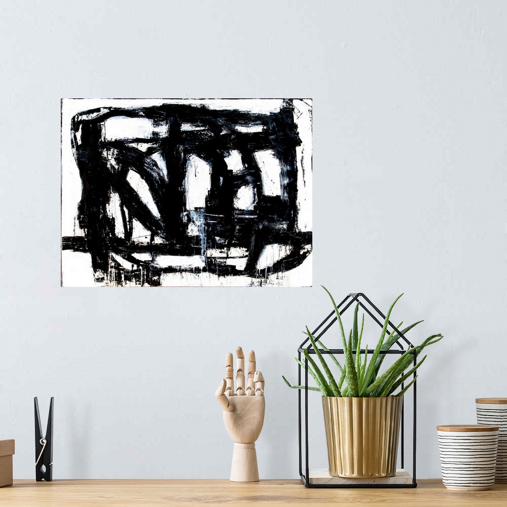 A bohemian room featuring A black and white abstract painting of bold, black brush strokes going in different directions an...
