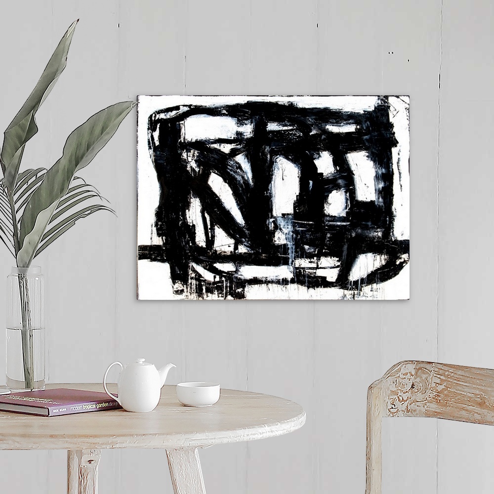 A farmhouse room featuring A black and white abstract painting of bold, black brush strokes going in different directions an...