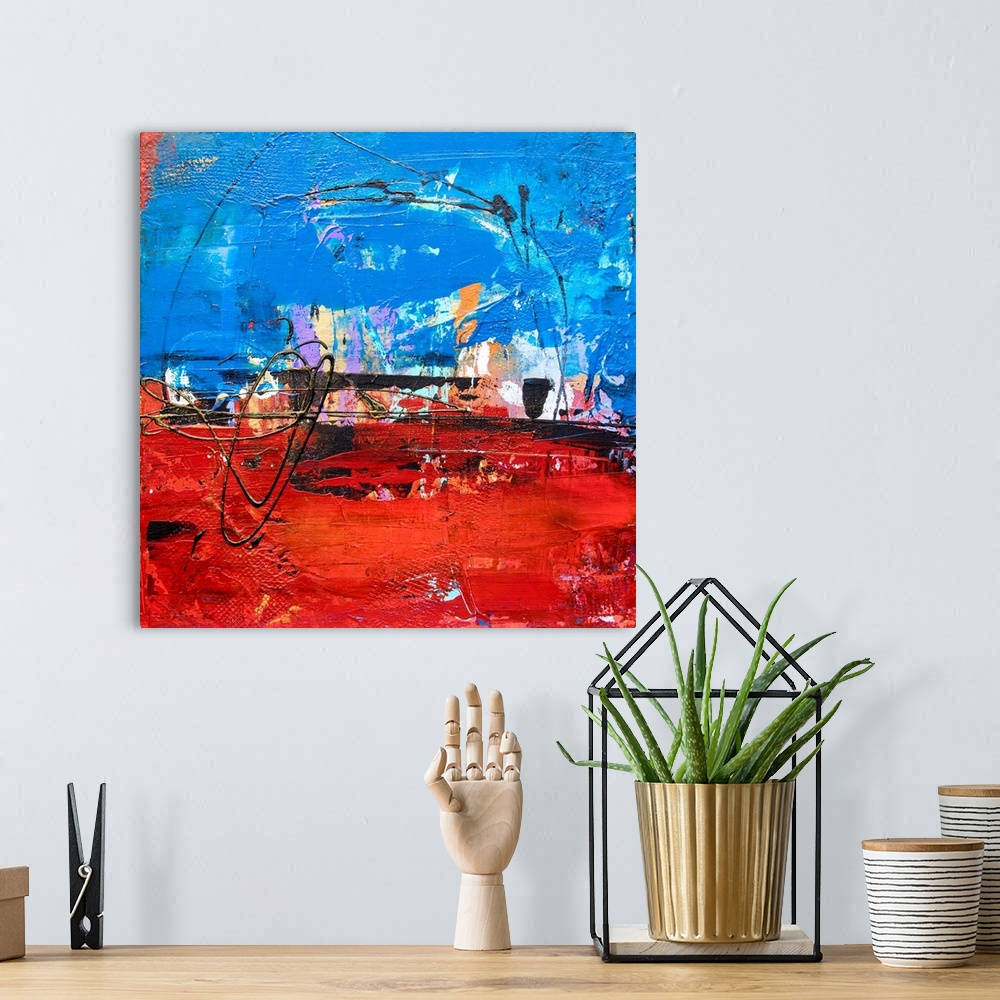 A bohemian room featuring Square abstract art with bright layers of paint and textures in shades of blue and red with pops ...