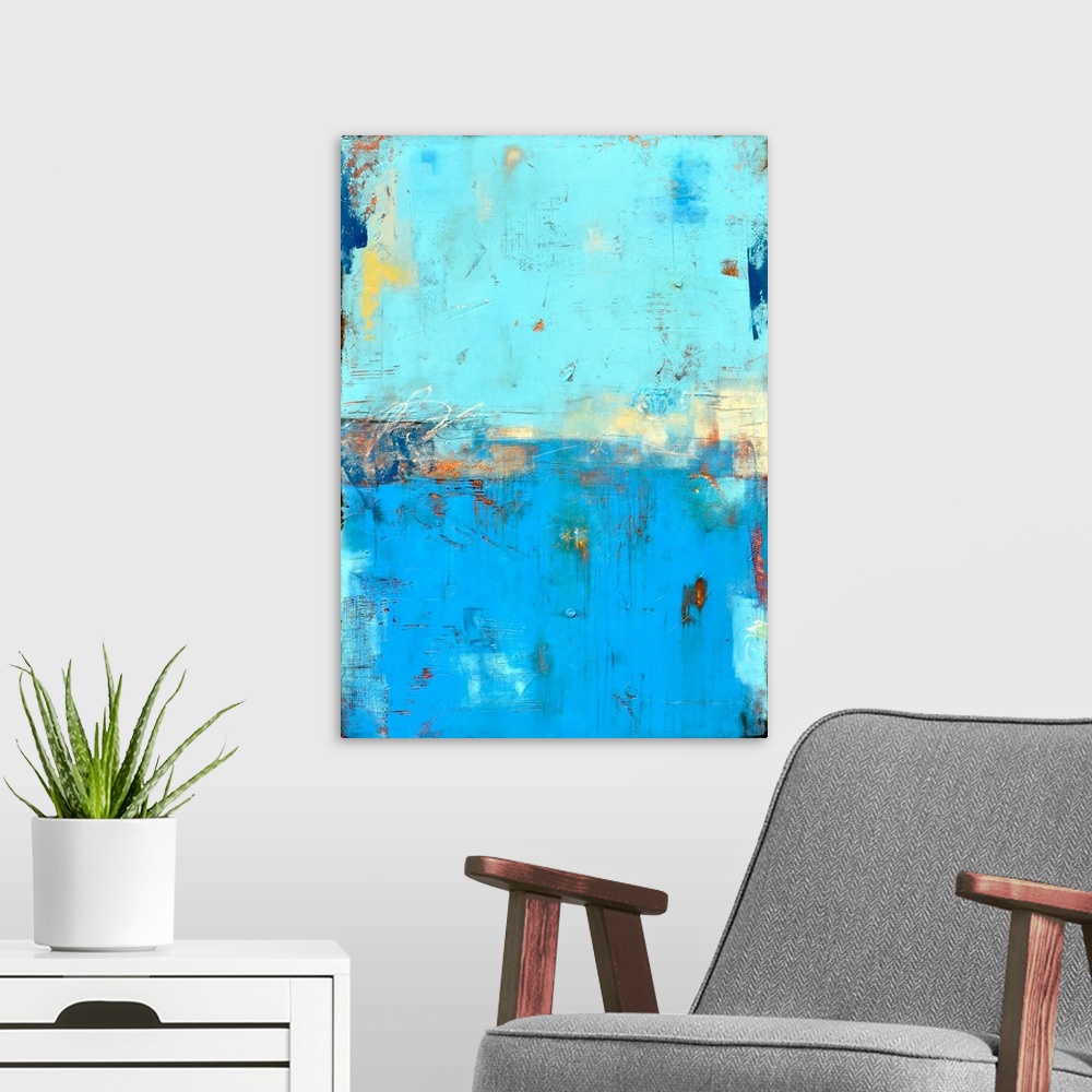 A modern room featuring Contemporary abstract painting using blue tones mixed with earthy tones.
