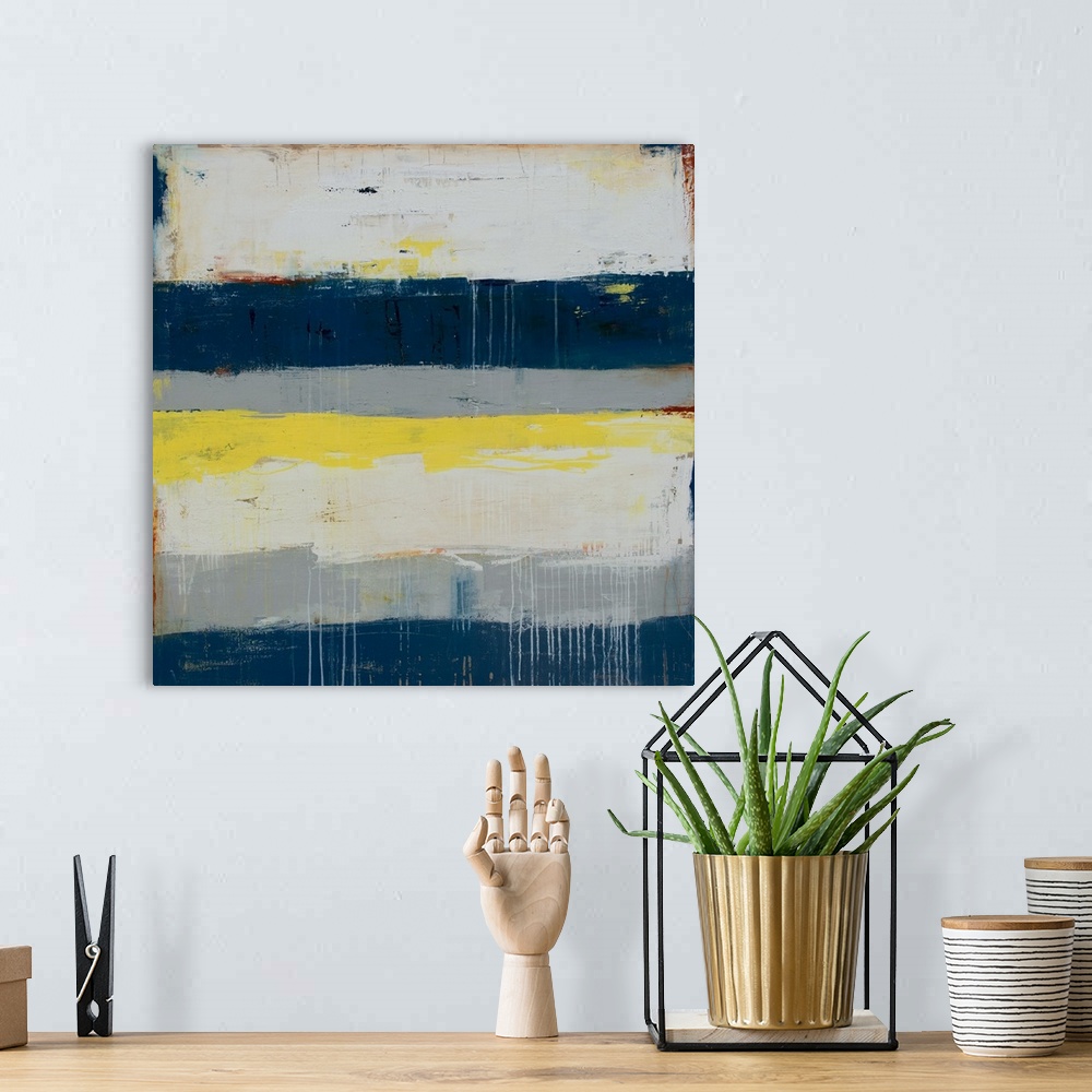A bohemian room featuring Horizontal striped abstract painting in shades of gray, blue, and yellow, with paint drips on top...