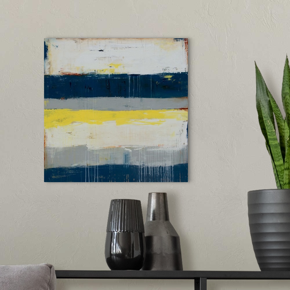 A modern room featuring Horizontal striped abstract painting in shades of gray, blue, and yellow, with paint drips on top...