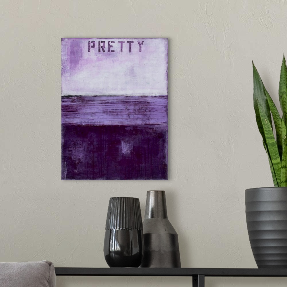 A modern room featuring Vertical abstract artwork created with different shades of purple and the word "Pretty" stenciled...