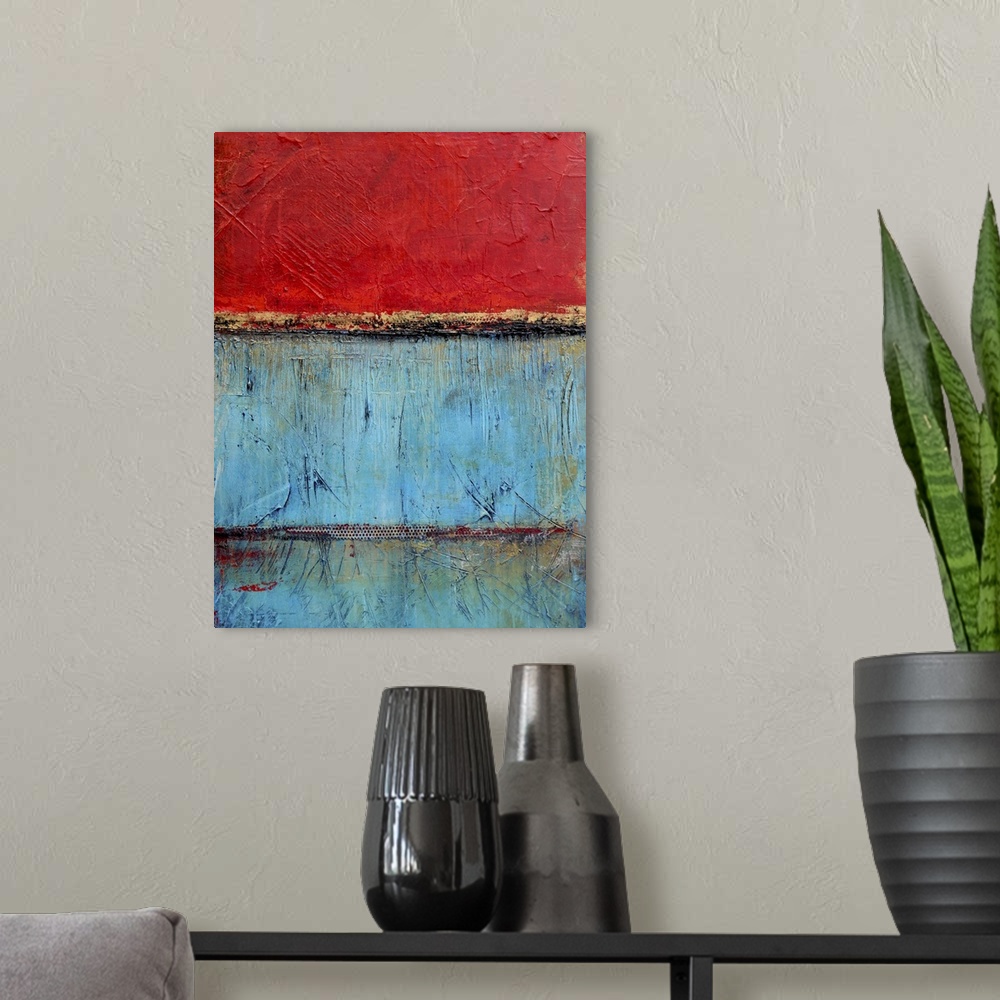 A modern room featuring Contemporary abstract painting using bright red and blue contrasting with each other.