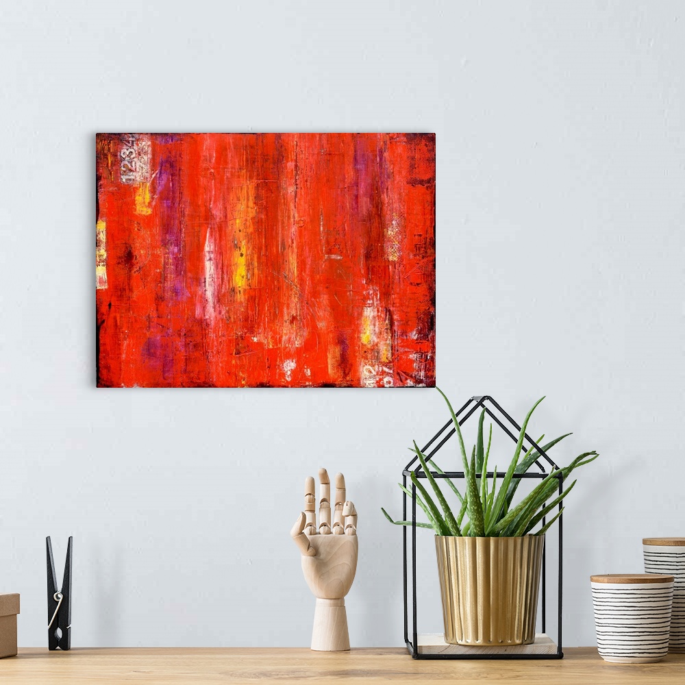 A bohemian room featuring Contemporary abstract painting using bright vibrant red with streaks of yellow.