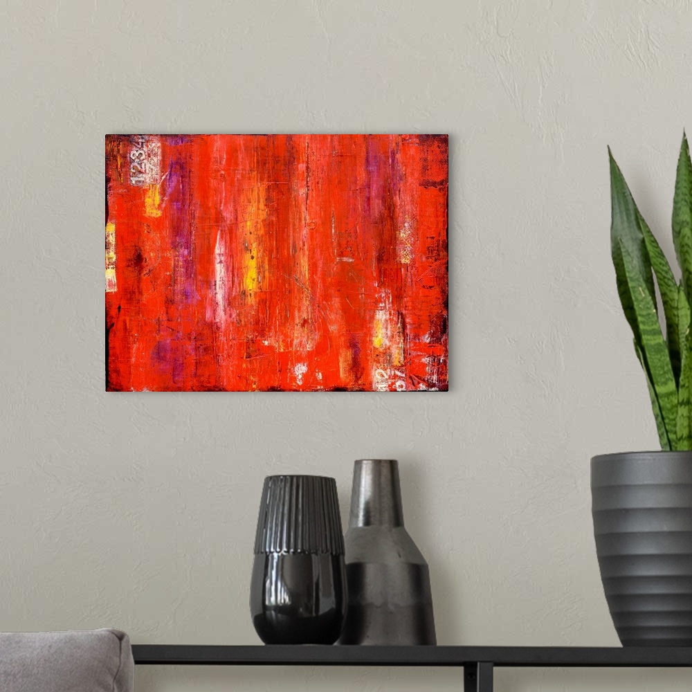 A modern room featuring Contemporary abstract painting using bright vibrant red with streaks of yellow.