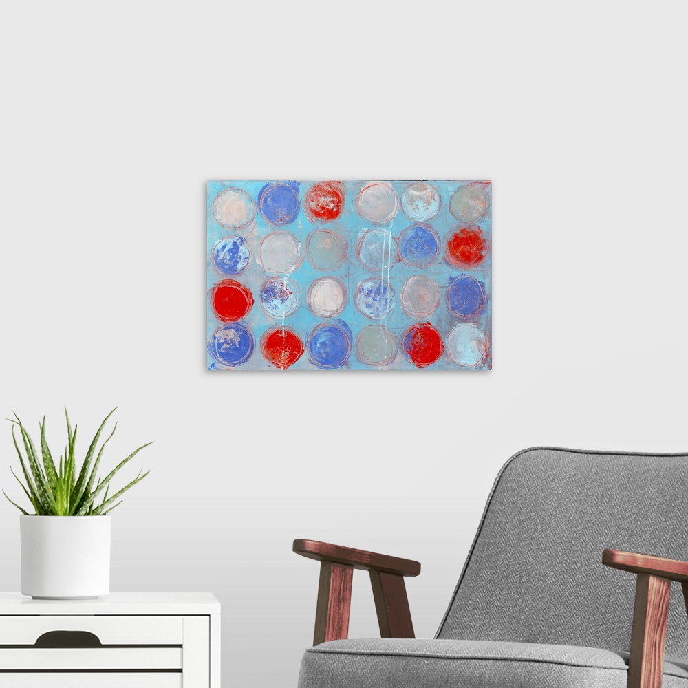 A modern room featuring A contemporary abstract painting of colorful circles against a pale blue background.