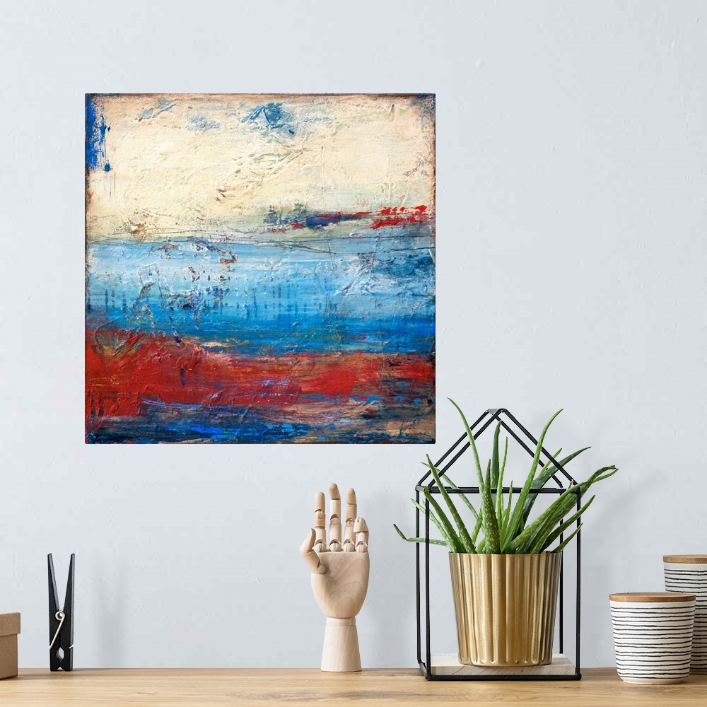 A bohemian room featuring Square abstract painting with heavy texture and layered paint in shades of blue, red, and white.