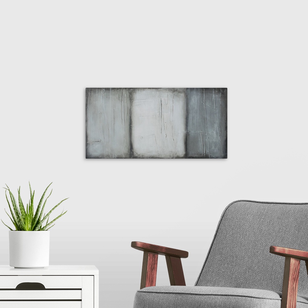 A modern room featuring Wide abstract painting made into three sections with different shades of gray and thin lines on t...