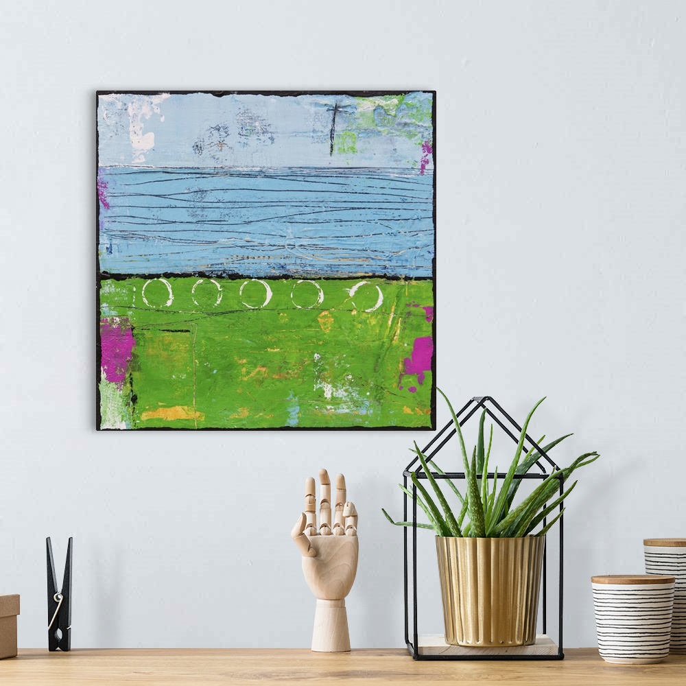 A bohemian room featuring Contemporary abstract painting using bright green and blue tones.