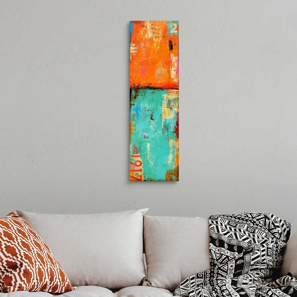 A bohemian room featuring Vertical abstract artwork of vibrant orange and teal colors that reveals grunge lettering and gra...