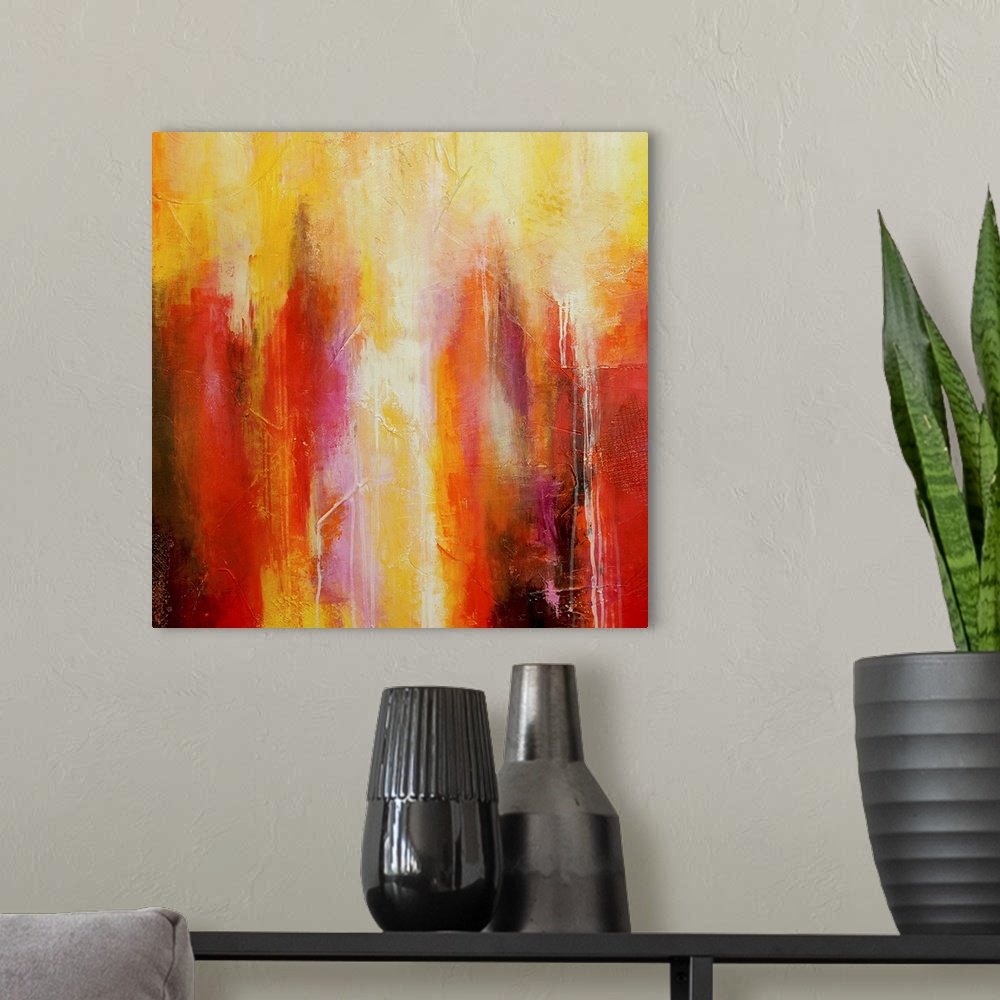 A modern room featuring Big abstract art includes different streaks of vibrant warm tones with a few sections of patterne...