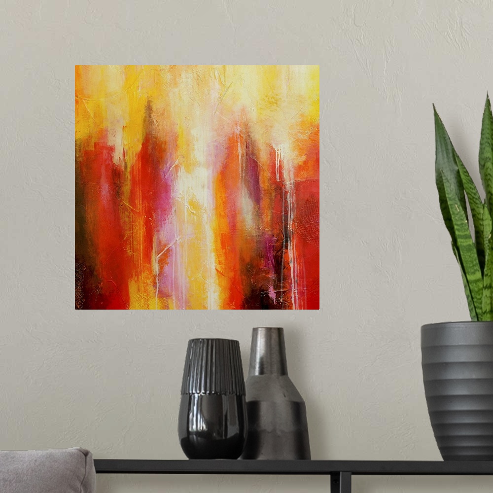 A modern room featuring Big abstract art includes different streaks of vibrant warm tones with a few sections of patterne...
