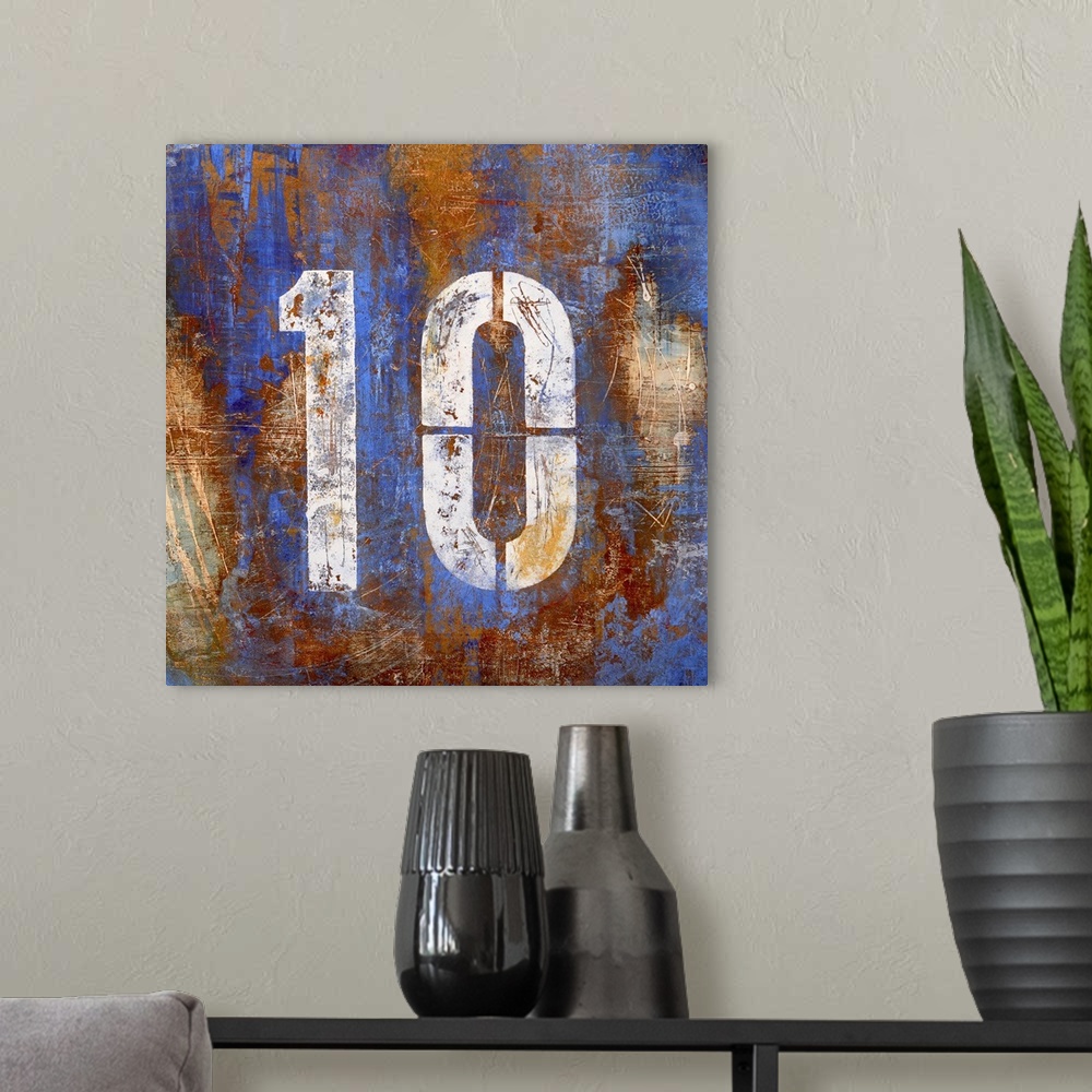 A modern room featuring Square abstract painting on canvas of a stenciled number ten on top of blotches of color.
