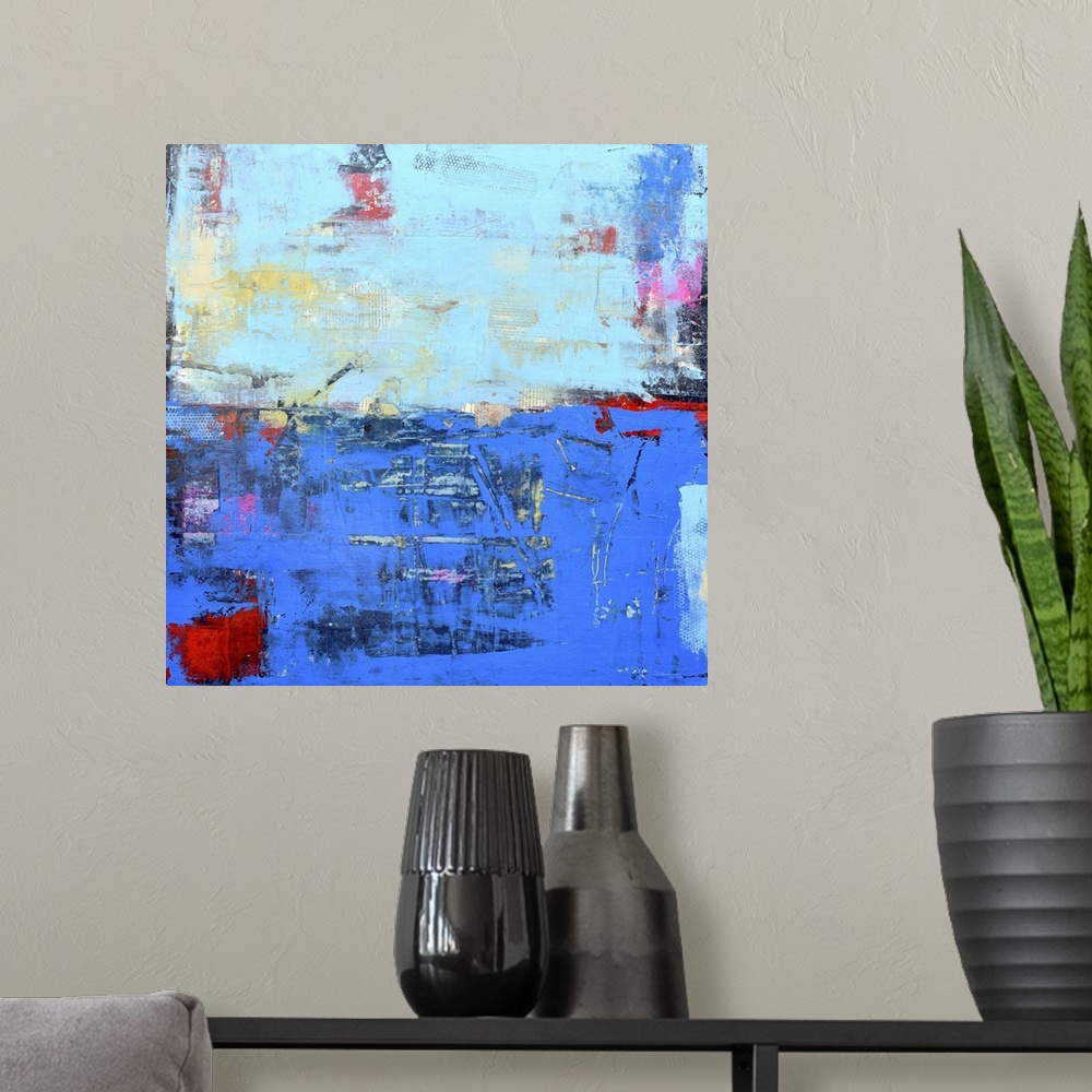 A modern room featuring A contemporary abstract painting using a dark and light blue meeting face to face.