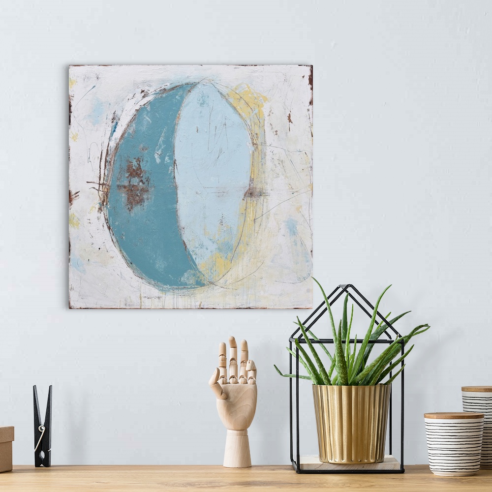 A bohemian room featuring Contemporary abstract painting of a crescent shape in pale blue against a putty colored background.