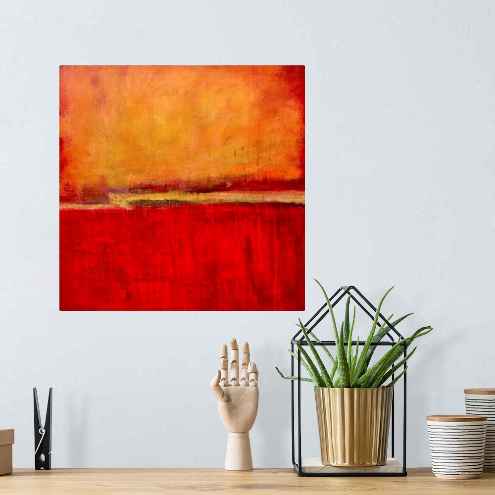A bohemian room featuring Square abstract artwork in fiery red and orange tones with simple, bold areas of color, resemblin...