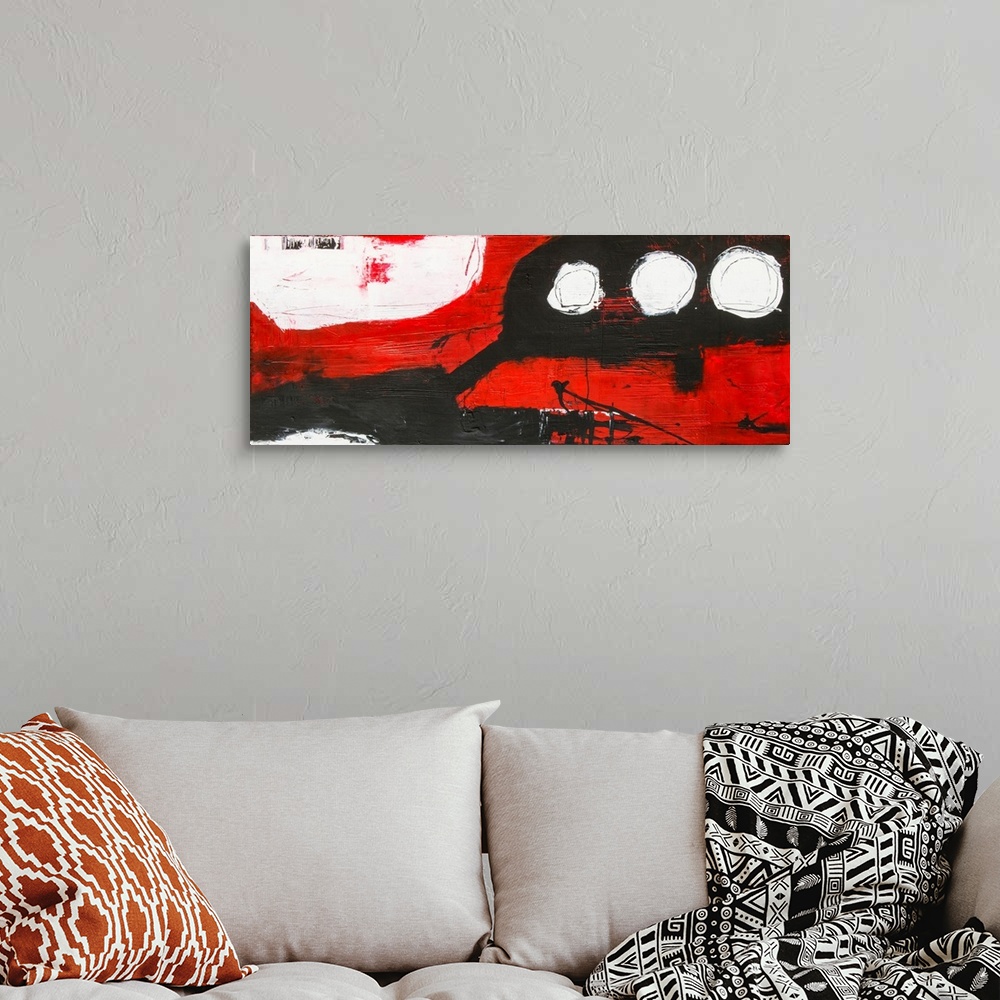 A bohemian room featuring A large abstract with bright red, white and black hues in textured paint. Black paint is dividing...