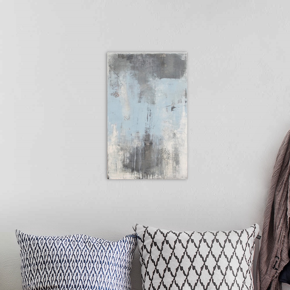 A bohemian room featuring Vertical abstract painting created with shades of gray, white, and light blue.
