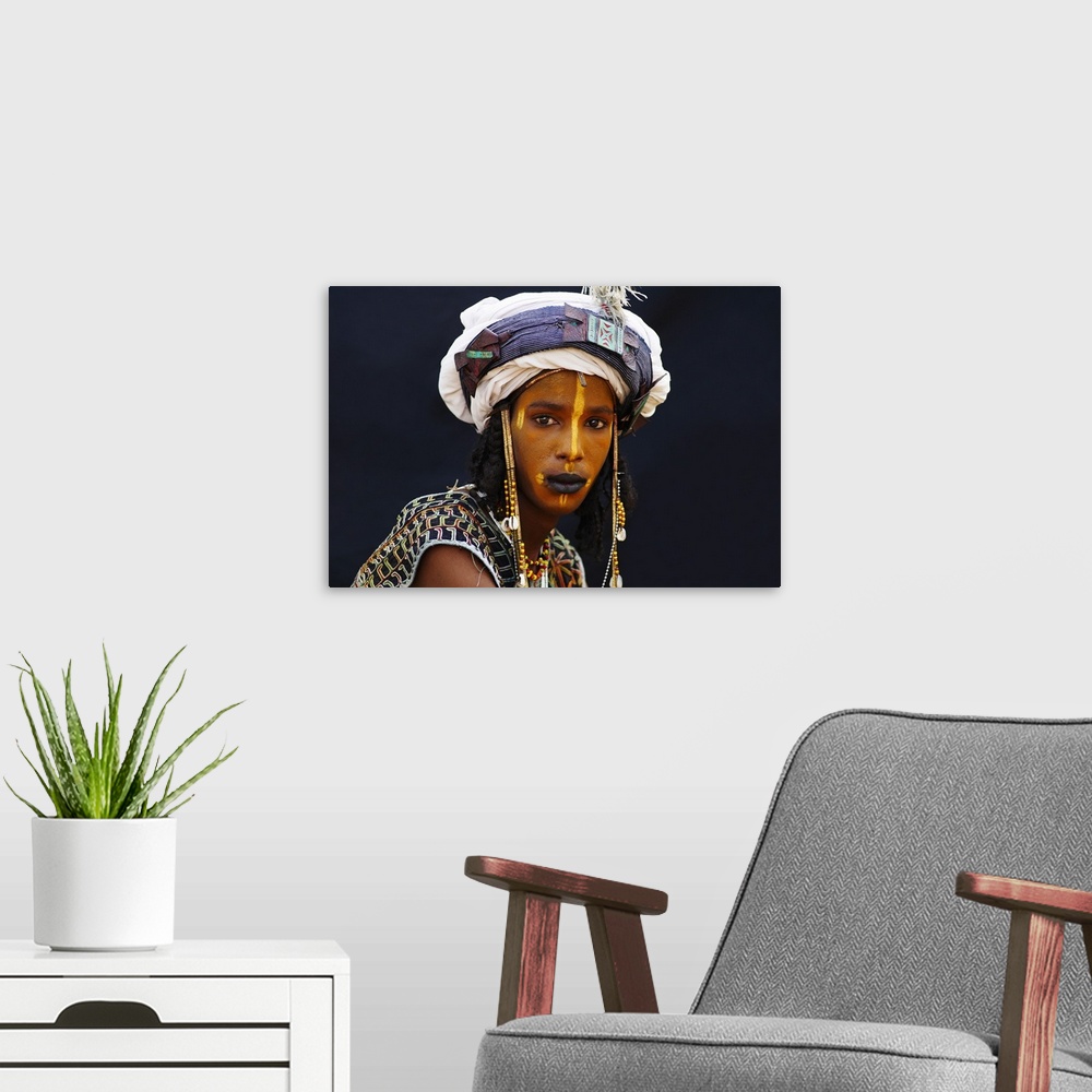 A modern room featuring Niger, A Wodaabe-Bororo boy with his face painted for the annual Gerewol male beauty contest