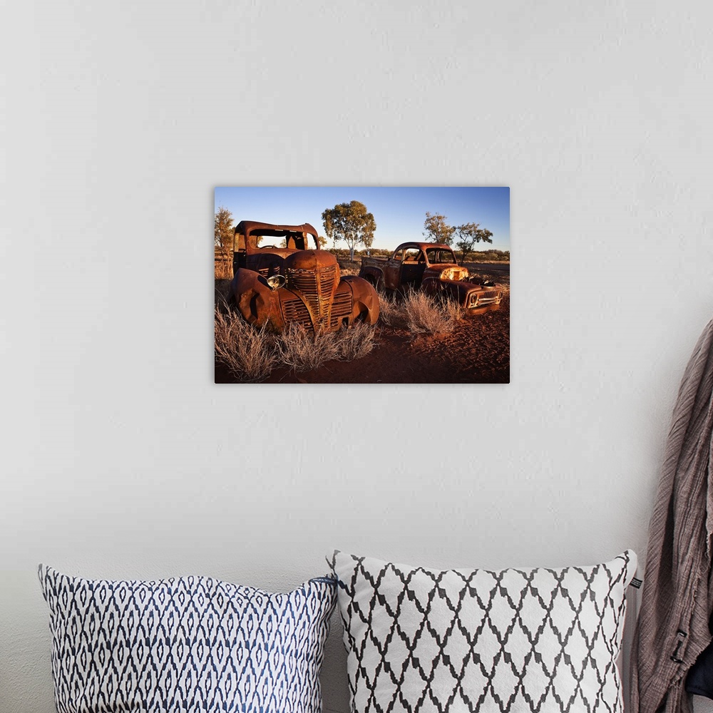 A bohemian room featuring Australia, Northern Territory, Oceania, Devil's Marbles, old car wreck in the desert
